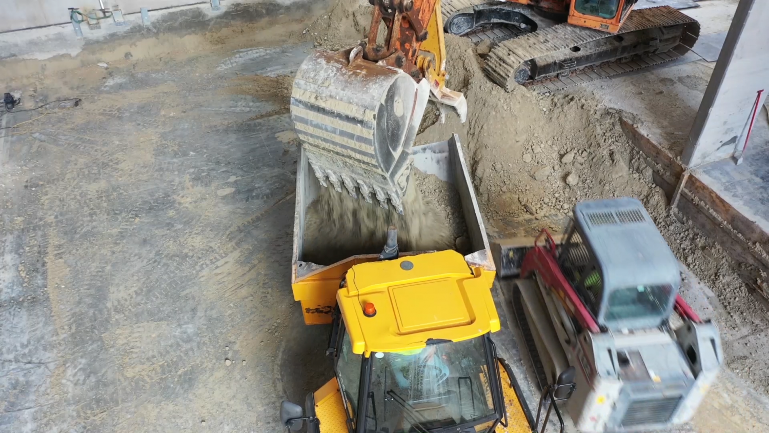 Excavator loading soil into dump truck