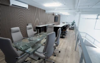 Mezzanine lounge at Excalibur Car Condominiums with glass conference table, wet bar with stools, and cable railing