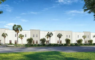 Rendering of Duffie North at Punta Gorda Airport Commerce Center, a long white commercial building with palm trees and