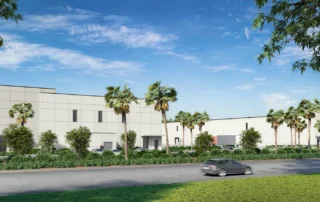 Rendering of Duffie North at Punta Gorda Airport Commerce Center: white warehouse buildings lined with palm trees by a road